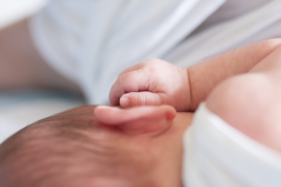 Detail of newborn baby ear and hand