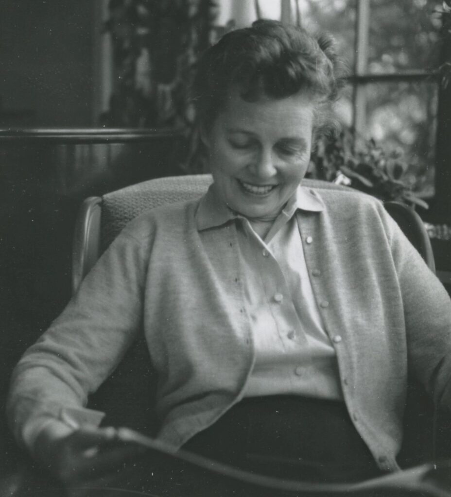 An undated black and white photo of Leona Zacharias, PhD, reading at Mass Eye and Ear.