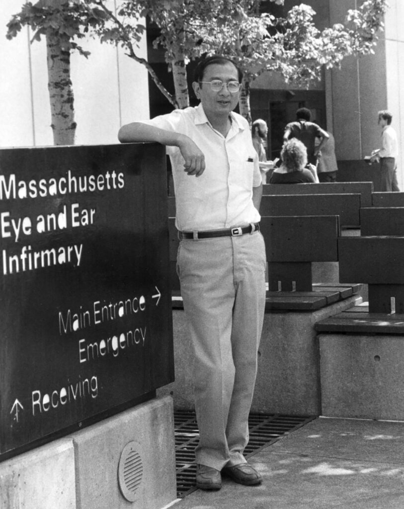 Dr. Kiang poses in front of the Mass Eye and Ear sign in this undated photo.