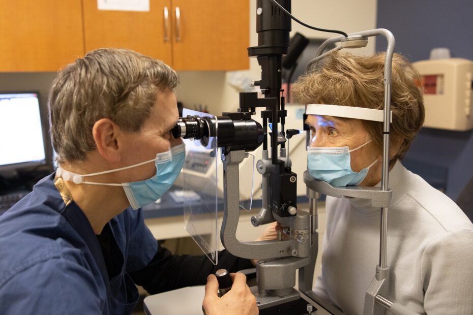 Dr. David S. Friedman, performs an eye exam on a female patient