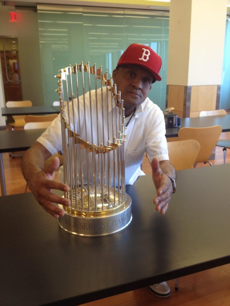 Walter Meeks photographed at the Mass Eye and Ear dinging room in 2013 with the Red Sox World Series trophy.
