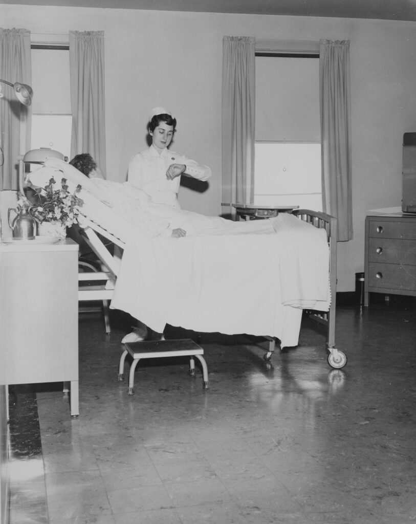 A nurse takes a reading and tends a patient, 1949