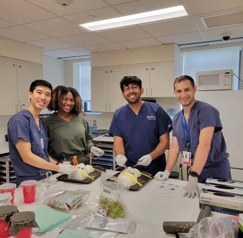 Two research scholars (centered) are pictured working in the Samuel and Nancy Jo Altschuler Ophthalmology Surgical Training Laboratory at Mass Eye and Ear in July, flanked by two Harvard Ophthalmology residents.