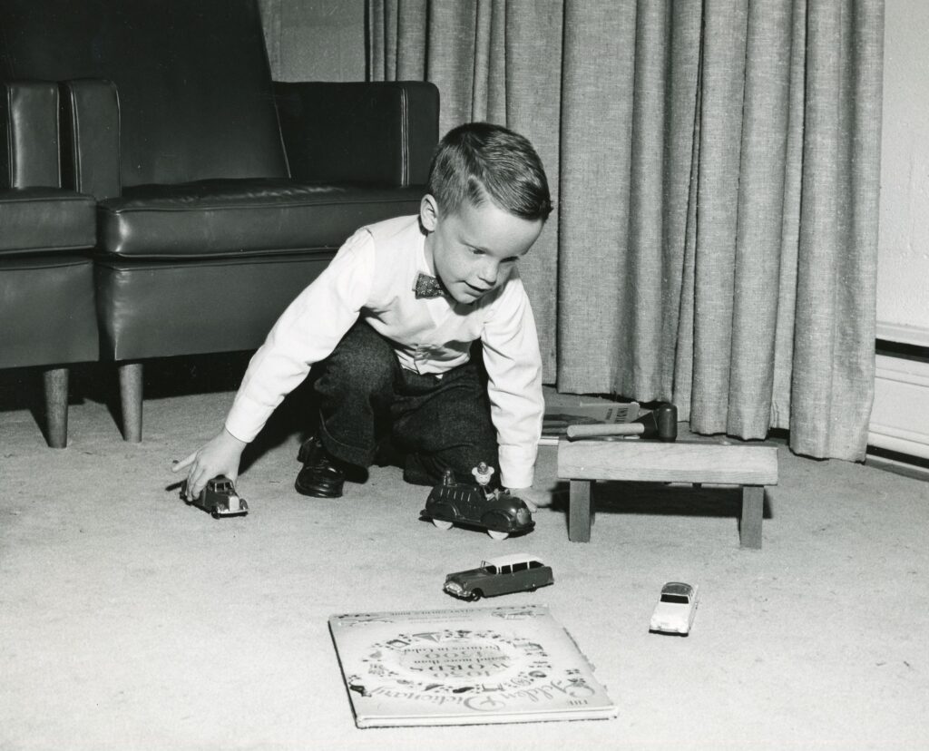 A patient with retrolental fibroplasia (now known as retinopathy of prematurity) plays with toy cars, 1956. 